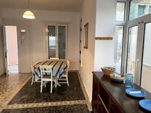 a dining room with a table and chairs at House with marina view in Plomari