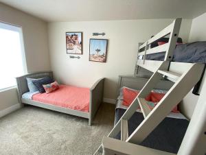 a small bedroom with two bunk beds and a bed at Kanab Family condo with yard & Hot Tub Close to Zion in Kanab