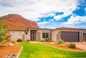 a house with a mountain in the background at Pet Friendly Southern Utah Luxury FamilyHome Views in Kanab