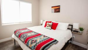 a bedroom with a large bed with red pillows at Pet Friendly Southern Utah Luxury FamilyHome Views in Kanab