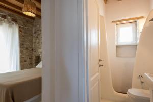 ein weißes Bad mit einem Bett und einem Waschbecken in der Unterkunft Villa Cornelia in Aliki + 44 Fotos