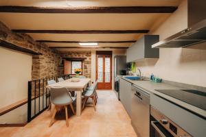 a kitchen and dining room with a table and chairs at Alojamiento rural la Mola 11 in Benasal