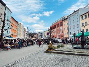 a group of people walking down a city street at Ferienwohnung Dreierlei in Wasserburg am Inn