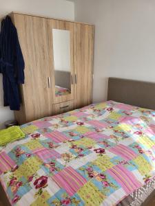 a bedroom with a bed with a quilt on it at Selva inn in Veenendaal +17 photos