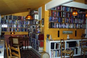 a room with several shelves filled with books at Arden Forest Inn in Ashland