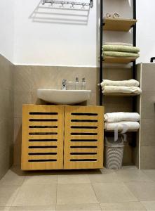 a bathroom with a sink and a toilet and towels at Rozy homes, Garuga Entebbe, next to lake Victoria in Wakiso +52 photos