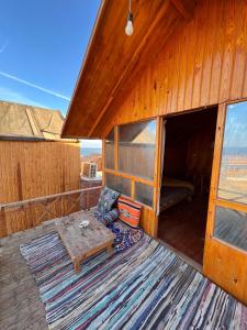 a room with a couch and a table on a deck at Full Moon Camp Sinai in Nuweiba +28 photos