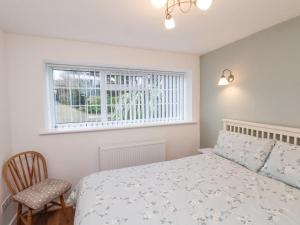 a bedroom with a bed and a window at Meadow Cottage in Scarborough