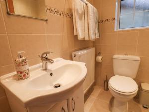 a bathroom with a sink and a toilet at Meadow Cottage in Scarborough +21 photos