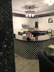 a kitchen with a black and white counter top at cozy penthouse in New Cairo in Al Khārijah +13 photos