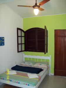 1 dormitorio con 1 cama y ventilador de techo en Hospedagem Casa De Familia, en Paraty