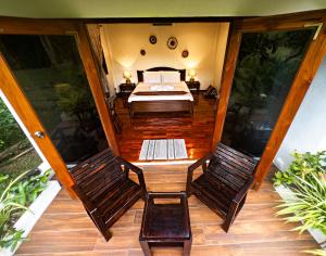 a bedroom with a bed and two chairs at The Hideaway Village in Ban Mae Hi +15 photos