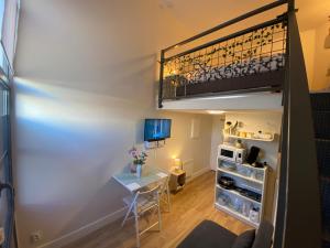 a room with a desk and a loft bed at Lespinet BNB - Duplex avec parking in Toulouse