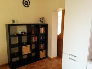 a black book shelf filled with books in a room at Holiday Home La Moranda in San Fior di Sopra