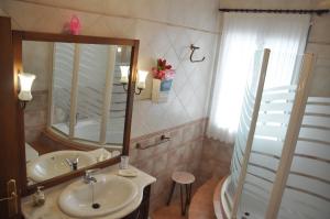 un bagno con lavandino e specchio di Casa Rural Los Galanes a Villanueva de los Infantes Altre 80 foto