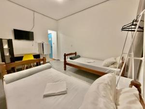 a hospital room with two beds and a tv at Pousada Family Consulado Americano in São Paulo