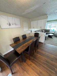 a living room with a wooden table and chairs at Photo Op with Sasquatch 2 min to walk Silver Mtn in Kellogg