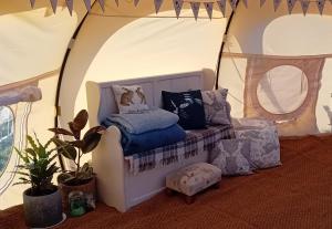 a room with a couch in a tent at Stargazer Bell Tent in Northrepps