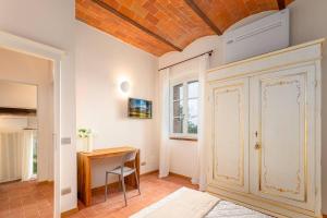 a home office with a desk and a door at Suite Leonardo in San Gimignano