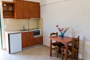 a small kitchen with a table and a sink at Villa Panorama in Moúdhros