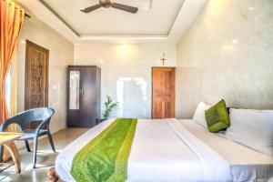 a bedroom with a large bed and a table at Calangute Sea Steps in Calangute