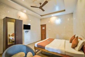 a bedroom with a bed with a ceiling fan at Calangute Sea Steps in Calangute
