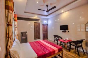 a bedroom with a bed and a table with chairs at Calangute Sea Steps in Calangute +18 photos