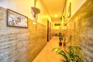 a hallway of a building with a painting on the wall at Calangute Sea Steps in Calangute