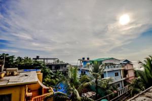 a view of a city with buildings and palm trees at Calangute Sea Steps in Calangute