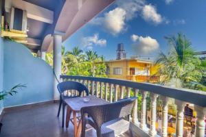a balcony with a table and chairs and a view at Calangute Sea Steps in Calangute
