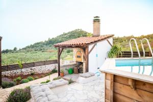 a house with a pool and a gazebo at Olive house Rezo in Hvar