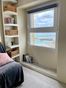a bedroom with a window with a view of the ocean at T2 dans l'intra-Muros VUE MER exceptionnelle in Saint Malo