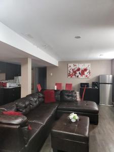 a living room with a brown leather couch at Blissful 2Bedroom Cozy Lowerlevel Unit PrivateEntrance in Gatineau +38 photos