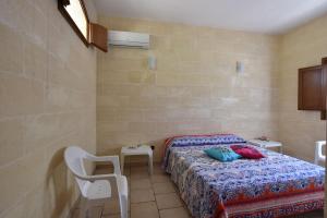 Ένα ή περισσότερα κρεβάτια σε δωμάτιο στο L'Ulivo - Relaxing Holiday Home