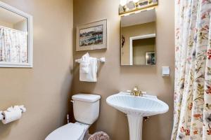 a bathroom with a toilet and a sink at Colors of the Coast in Santa Barbara +15 photos