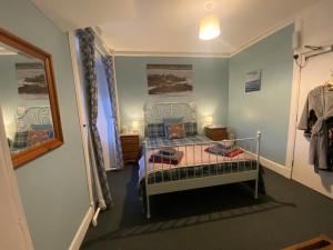 a bedroom with a bed in a room with a window at Forse of Nature in Latheron