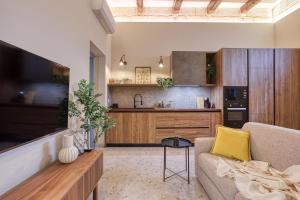 a living room with a couch and a kitchen at Beautifully Renovated 3BR Sliema Townhouse in Sliema