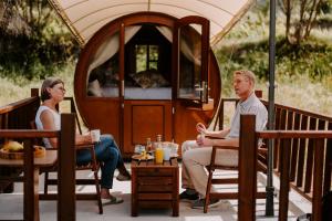 a man and a woman sitting on a porch at Finca Seguró in Sella