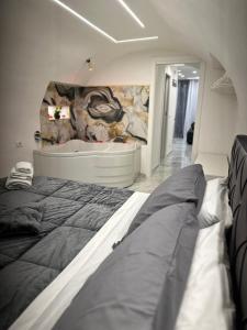 a bedroom with a large bed and a bath tub at Suite Sanità in Naples