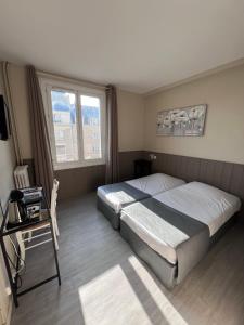 Postel nebo postele na pokoji v ubytování Hotel De l'Univers