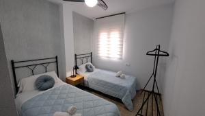 Ein Bett oder Betten in einem Zimmer der Unterkunft Apartamentos Maria Cristina con parking gratis