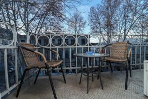 two chairs and a table on a balcony at Leon Rooms in Tbilisi City +124 photos