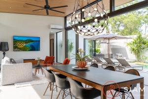 a dining room with a table and chairs at Villa Ami 3br & Private Pool in Bang Rak Beach