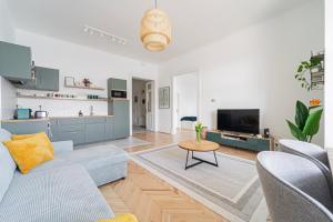 a living room with a blue couch and a table at Duna Panorama Apartment in Budapest