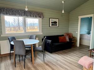 a living room with a table and a couch at Guesthouse Birkifell in Nesjum
