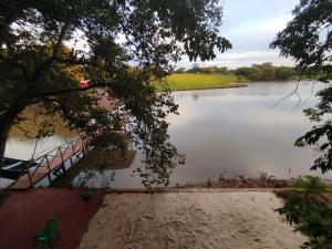 a view of a lake with a bridge over it at Chalet del lago Don Asterio in Ciudad del Este