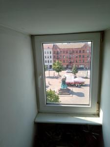 a window in a room with a view of a courtyard at Roof-Top View Over Möllevångstorget in Malmö