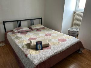 a bed with a quilt with a clock on it at Roof-Top View Over Möllevångstorget in Malmö
