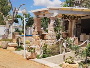 a garden in front of a building with a pavilion at Villa Allori, via degli allori in San Pietro in Bevagna in San Pietro in Bevagna