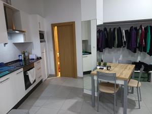 a kitchen with a table and chairs in a room at Finisterrae Centro in Finisterre